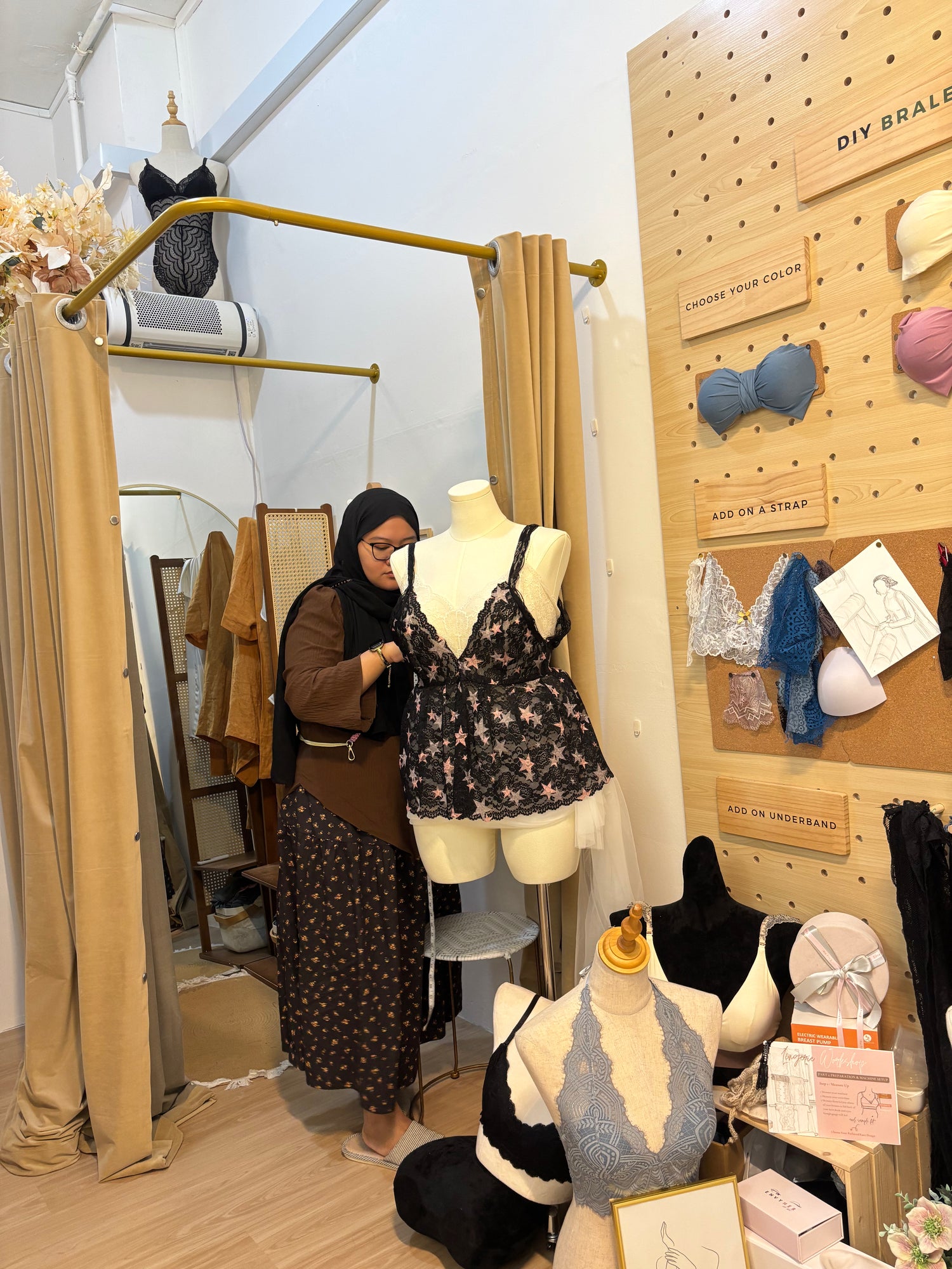 adjusting the gathers of a handmade babydoll top on a sewing machine during an apparel construction workshop