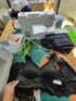 Close-up of a handmade black lace bralette project on a work table with sewing tools and specialized machinery during an intimate wear workshop